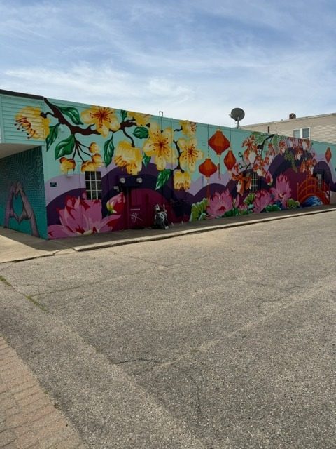 Floral mural on Sammy's Nails building — Holland MI